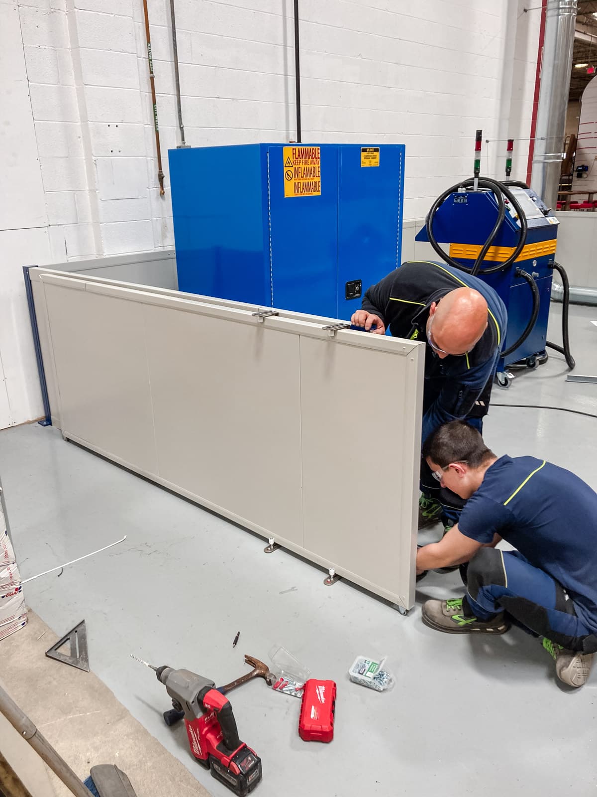 Airserco team members installing A2L refrigerant charging system enclosure